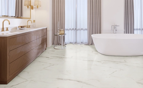 Marble floors in bathroom, tub and beige drapes 
