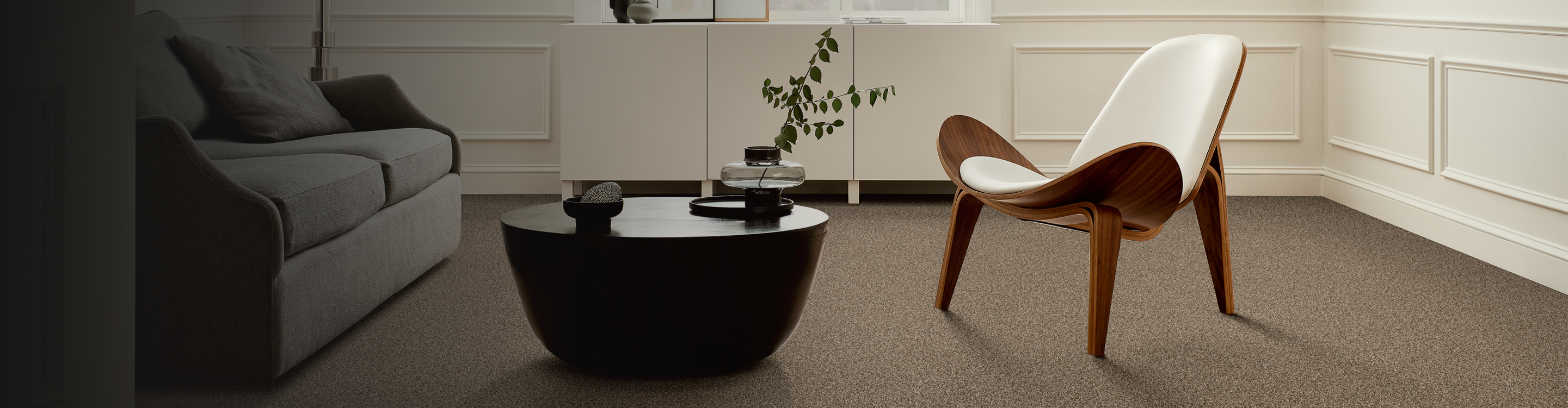 Seating area with brown carpet and modern chair
